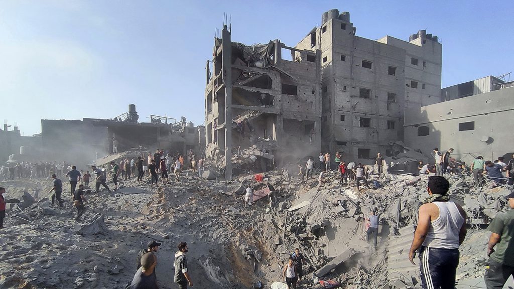 Palestinians inspect the damage of buildings destroyed by Israeli airstrikes on Jabaliya refugee camp on the outskirts of Gaza City, Tuesday, Oct. 31, 2023 (AP Photo/Abdul Qader Sabbah)